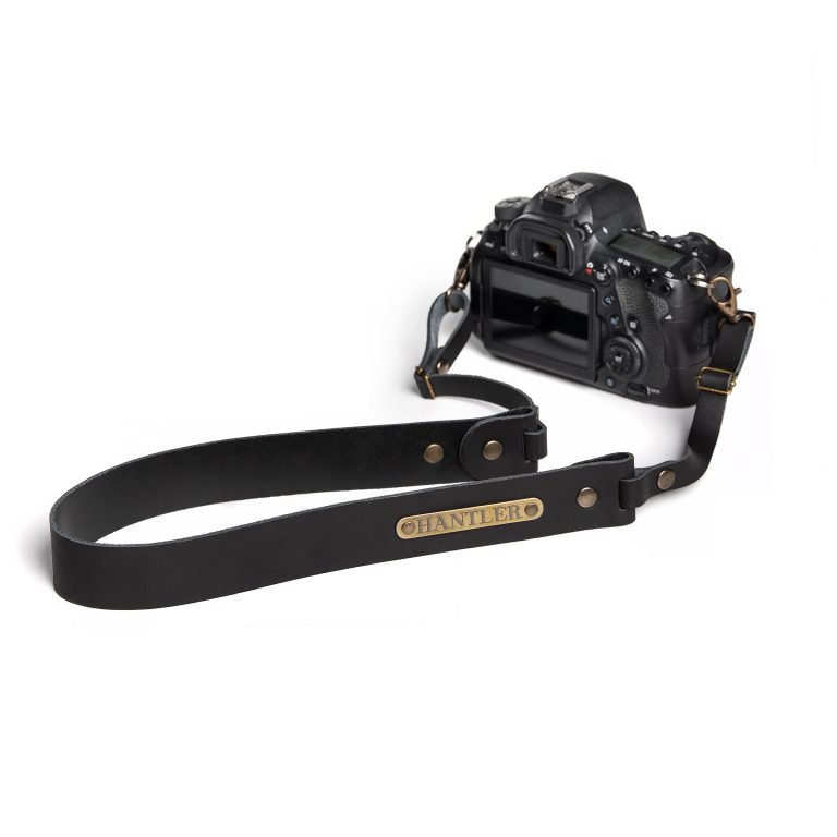 The Hantler's handmade black leather neck strap wich can be personalized with your own name on the metal tag.