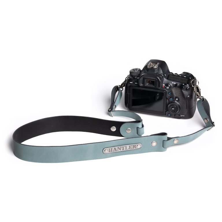 The Hantler's handmade blue leather neck strap wich can be personalized with your own name on the metal tag.